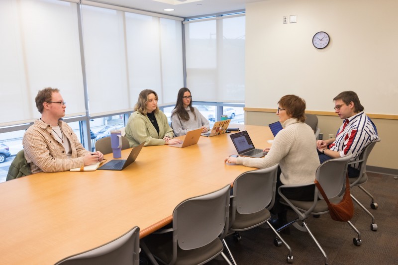 Lauren Dula and Matthew Uttermark meet with their student research collaborators: (from left) Andrew Clark, Francesca Bové and Emily Chambers.