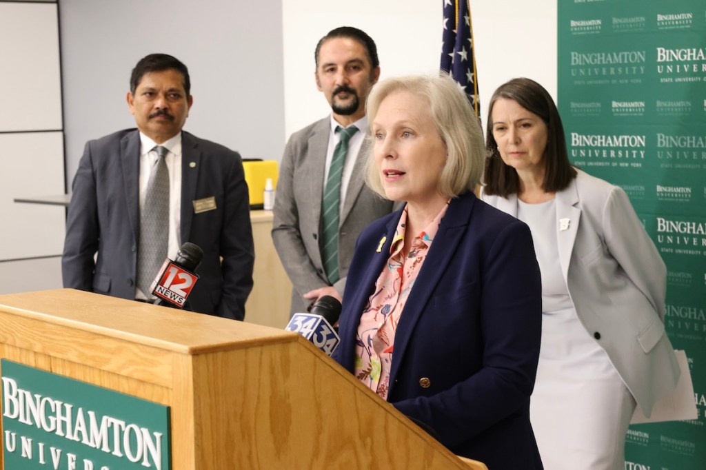 Sen. Kirsten Gillibrand announces a new bill, the Professional Student Degree Act, with (back left to right) School of Pharmacy and Pharmaceutical Sciences Dean Nagaraju, Decker College of Nursing and Health Sciences Dean Mario Ortiz, and Binghamton University President Anne D'Alleva. Image Credit: Jonathan Cohen.